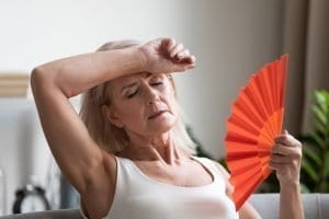hot woman with fan | The Menopause Association
